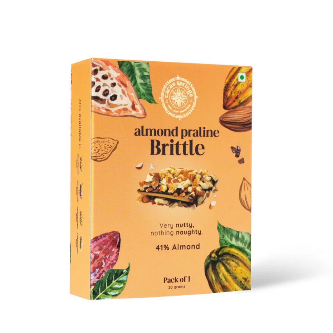A pack of Cacao Springs Almond Praline Brittle with the product visible through a cut window on the packaging.