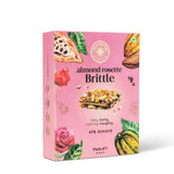 A pink box of Cacao Springs Almond Rosette Brittle with an image of the product, almonds, and a rose on the front.