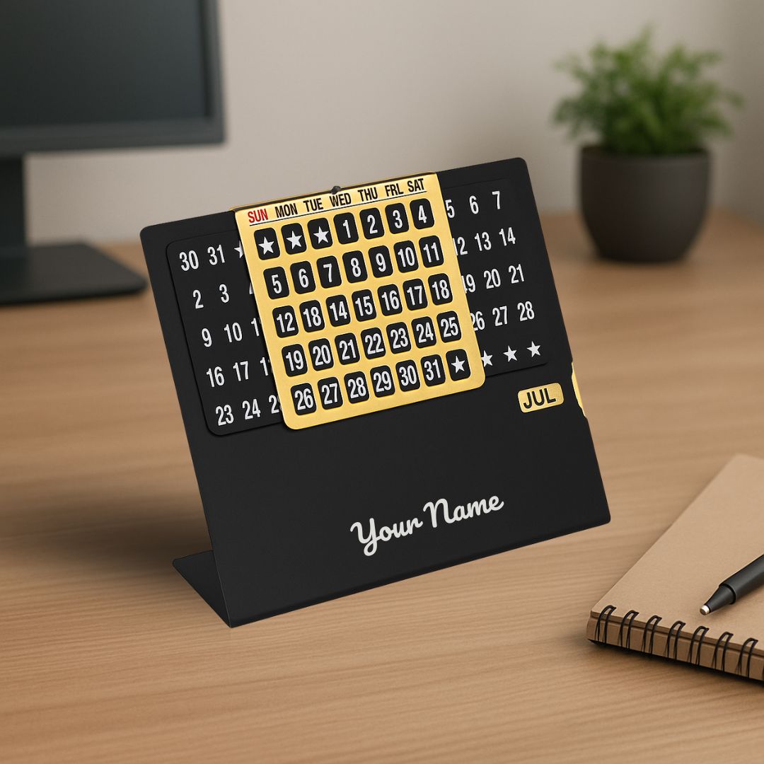 Small desk calendar with a black stand and yellow numbers on a wooden surface.