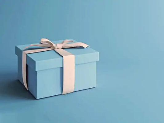 Light blue gift box tied with a cream-colored ribbon.
