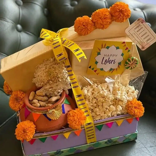 Colorful gift box filled with snacks and decorations for Lohri celebration.
