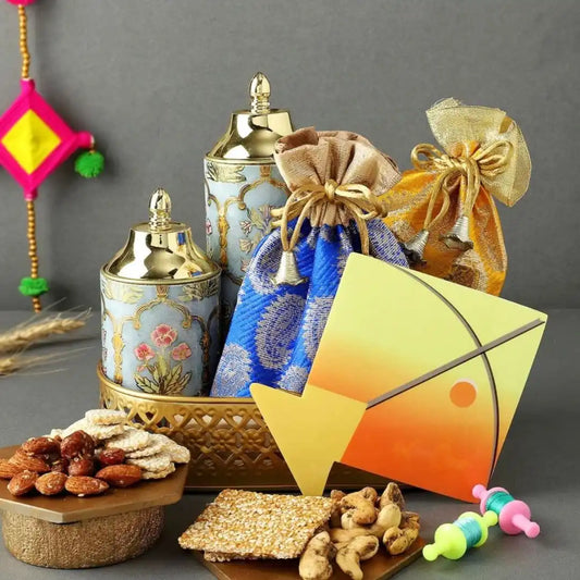 Decorative gift arrangement featuring ornate jars, colorful pouches, and assorted snacks.