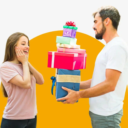 Stack of colorful gift boxes being presented by one person to another.